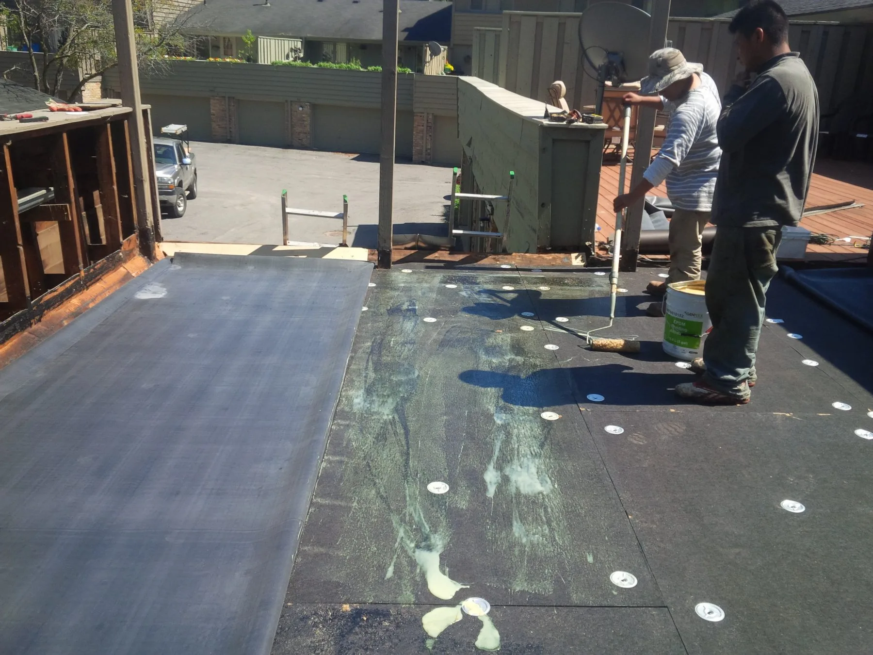 Roofers installing a flat roofing system