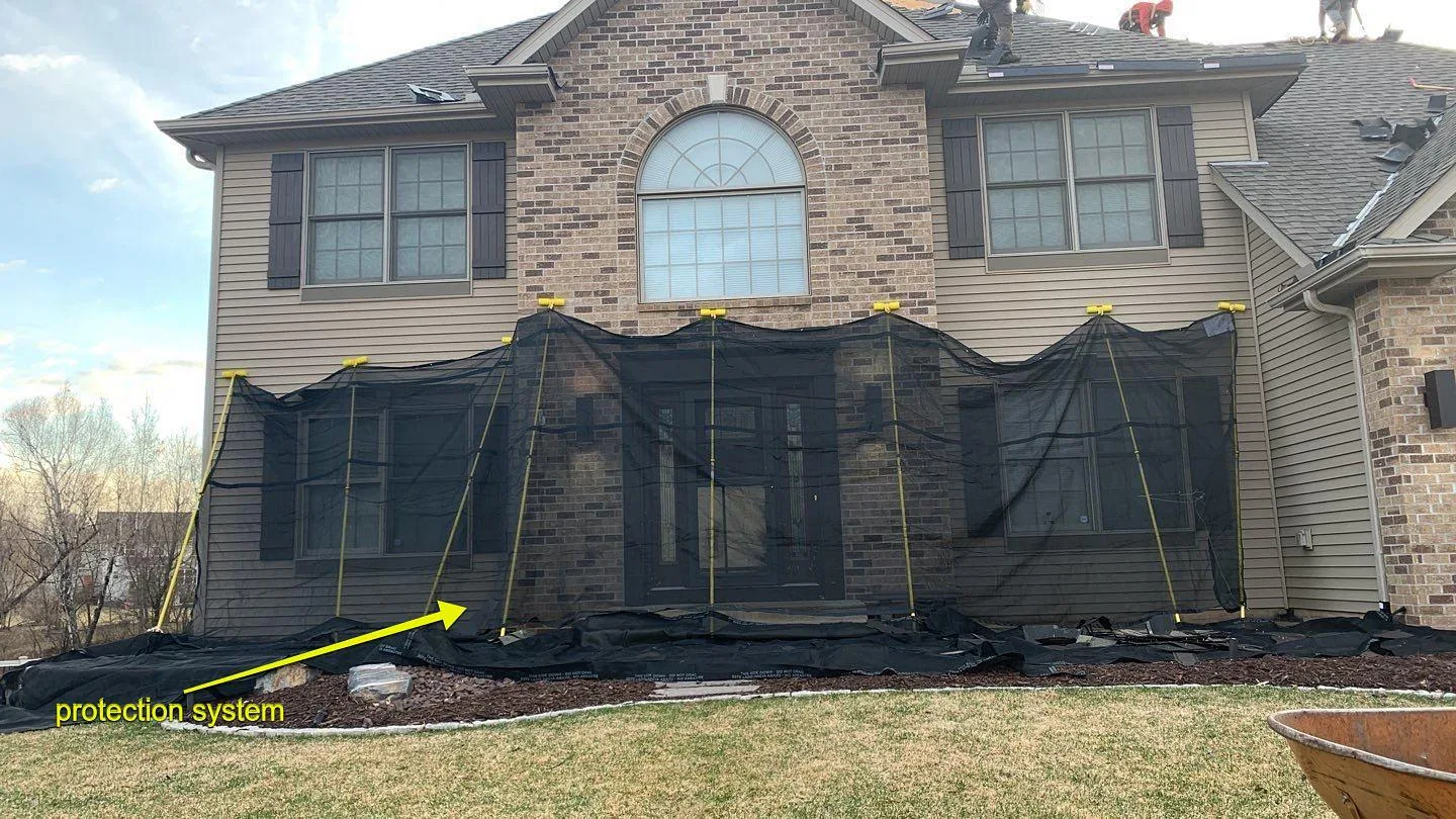 Protective wall coverings hung across the front of a house